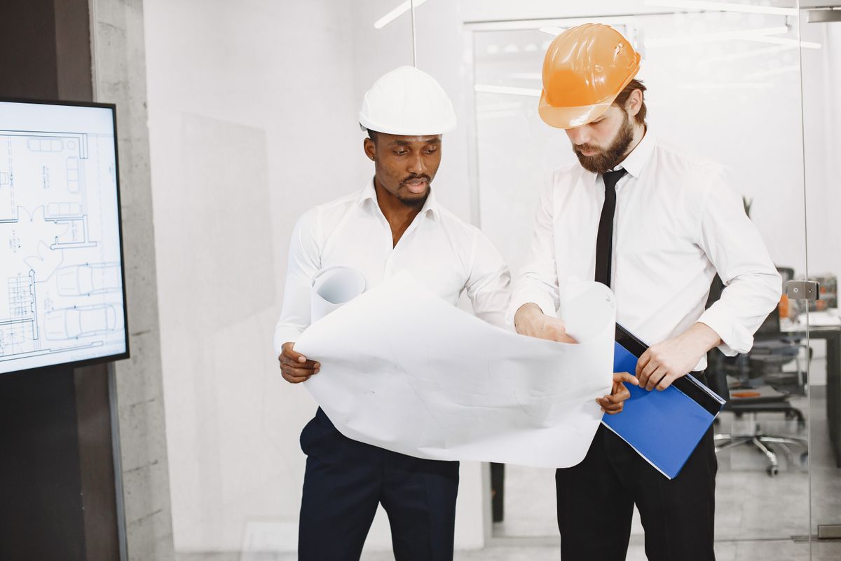 Architects consulting together over building plans